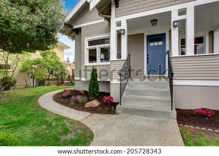 House exterior with entrance porch. View of staircase and front yard landscape