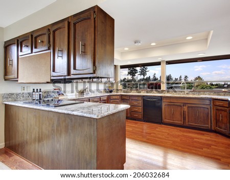 Spacious kitchen room with dark brown storage combination