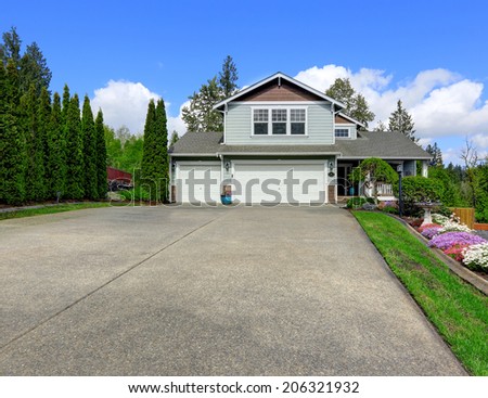 House exterior with curb appeal. View of entrance porch, garage and driveway.