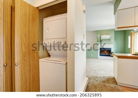 Empty house interior. VIew of laundry appliances built-in the empty wall cabinet