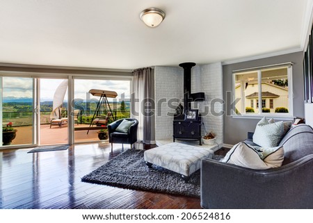 Elegant furnished corner in luxury house living room. View of antique stove with white brick background, coach and chair.