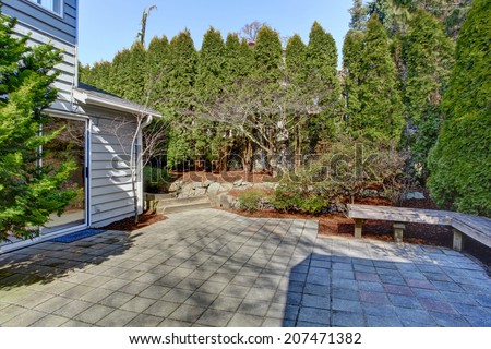 House backyard with tile floor walkout deck and landscape