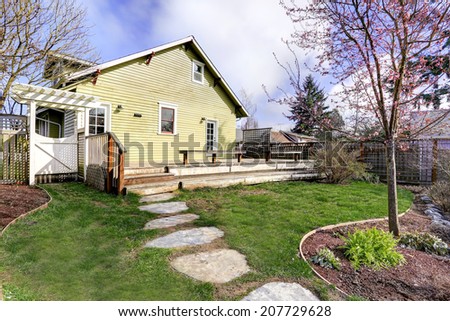 House with walkout deck and small garden. Early spring