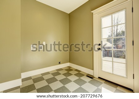 Empty entrance hallway with glass door and tile floor