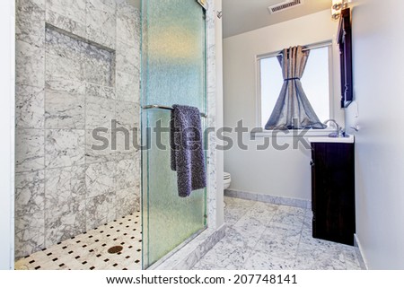 Bathroom with granite tile floor and granite tile wall trim in luxury house