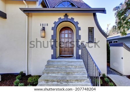 Beautiful ivory english tutor house with tile arch trim and stairs