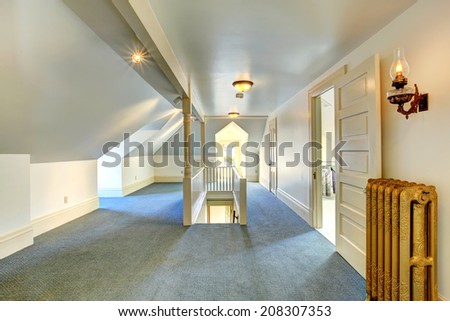 Empty upstairs room with vaulted ceiling and light blue carpet floor
