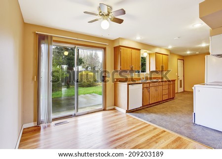 Kitchen room with empty dining area and slide door to backyard