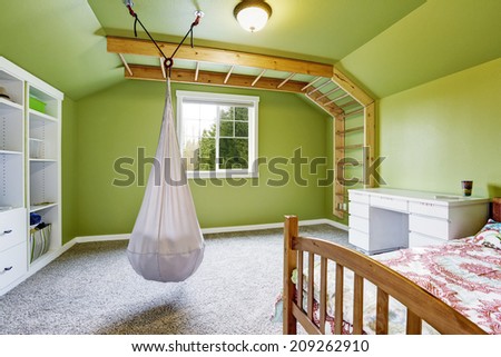 Kids room interior in bright green with attached ladder to the wall and hanging chair