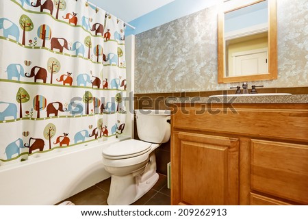 Bathroom interior with cheerful curtain and wooden cabinet with small mirror