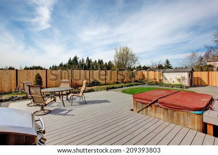 Backyard walkout deck with small patio area and jacuzzi
