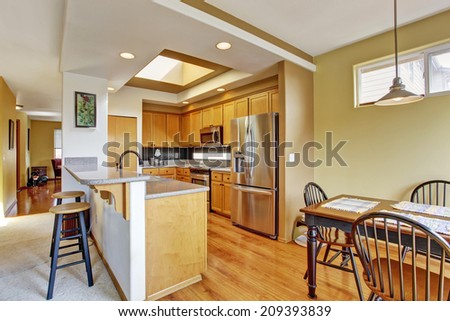 Small kitchen room with skylight and wooden dining table set