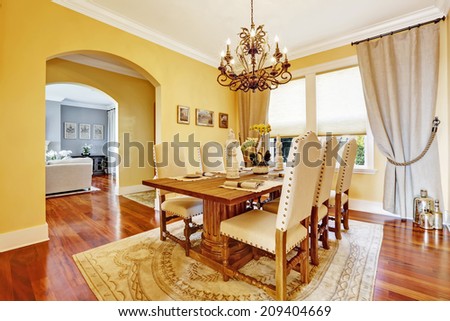 Bright luxury dining room with rich carved wood table