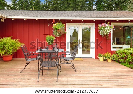 Beautiful bright red house with patio table on  walkout deck