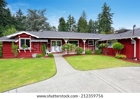 Beautiful red house with curb appeal. View of entrance porch with walkway