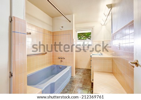 Ivory bathroom with blue bath tub. Unique modern old home build in 1952.