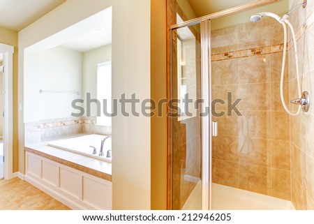 Bathroom interior. Glass door shower with tile wall trim