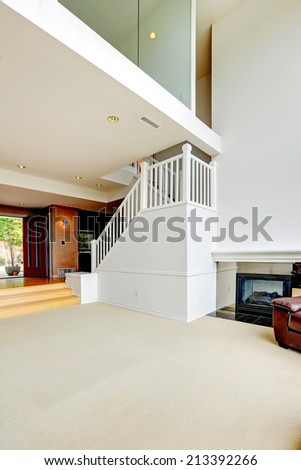 Bright empty house interior with staircase. View of loft