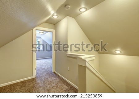 Ivory upstairs hallway with carpet floor, vaulted ceiling and staircase