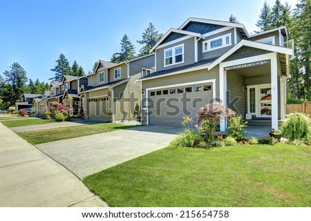 Classic house exterior. Entrance porch with driveway and front yard landscape