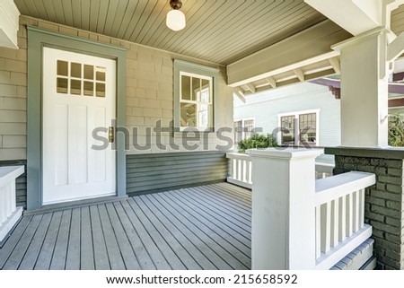 House entrance porch with white wooden door and white railings