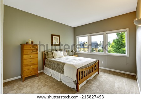 Bedroom interior in grey color with wooden bed, nightstand and dresser