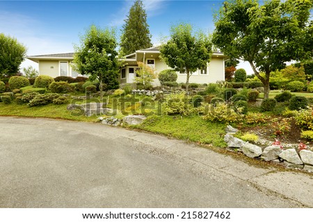 Ideas for front yard landscape design. Garden with trees and rocks