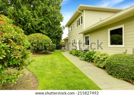 Beautiful backyard garden with walkway and rhododendron bushes. Real estate in Federal Way, WA