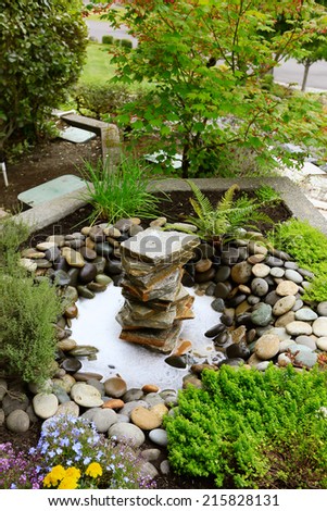 Ideas for landscaping home garden. Fountain with rocks.