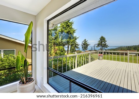 Bright room with glass walls. House with large walkout deck
