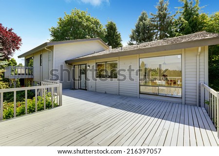 House with spacious walkout deck and large window