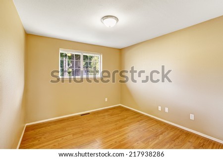 Small empty room with window and new hardwood floor