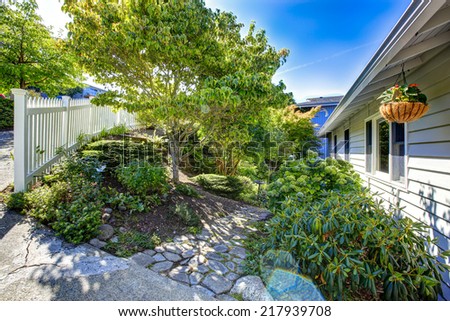 Fenced front yard with beautiful landscape design and stone walkway. Real estate in Washington