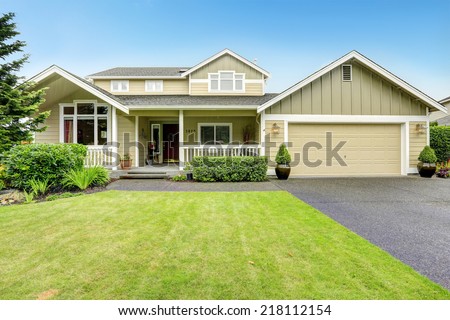 House exterior. Spacious walkout deck with railings. Garage with driveway