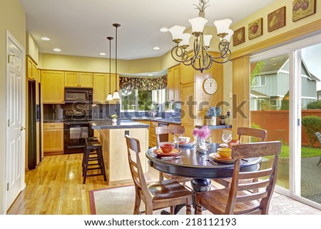 Bright dining area in kitchen room with exit to backyard patio