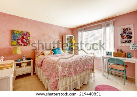 Cozy bedroom interior in pink color with white iron bed
