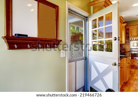 Double white door in the kitchen room with exit to backyard area