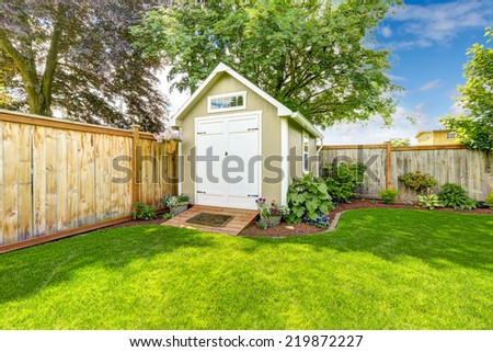 Beautiful new shed with flower bed on backyard area