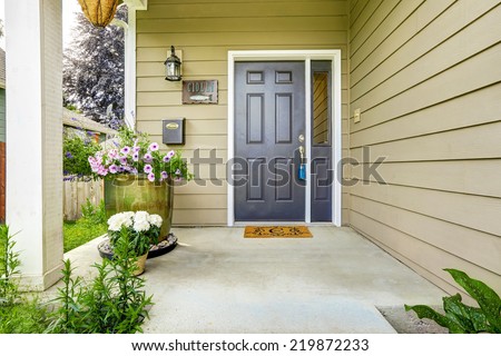 Entrance porch with concrete floor decorated with flower pots