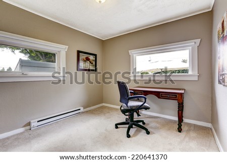 Light grey office room with two windows. Furnished with wooden desk and whirlpool chair