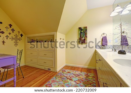 Kids bathroom interior with vaulted ceiling. Bathroom vanity cabinet with mirror., built-in cabinet with drawers and table