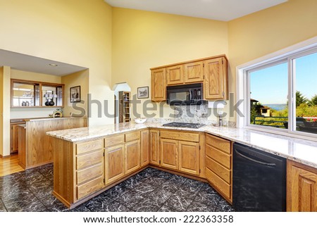 Beautiful kitchen room with high vaulted ceiling black granite tile floor and granite tops
