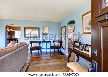 Light blue living room corner with antique chairs and table