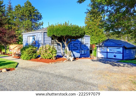 Light blue  house with garage and front yard
