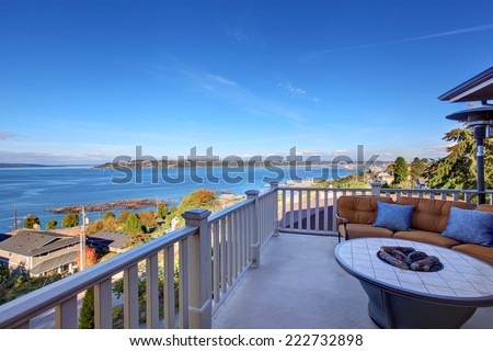 Cozy patio area with comfort settee and fire pit. Deck with Puget Sound view. Tacoma, WA