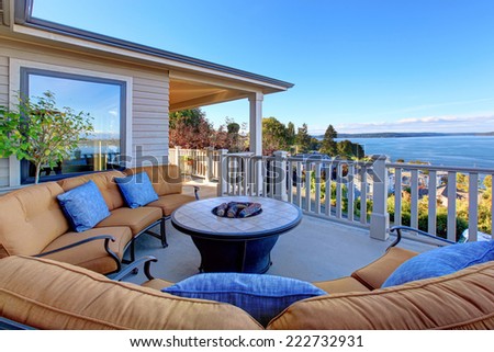 Cozy patio area with comfort settees and fire pit. Deck with Puget Sound view. Tacoma, WA