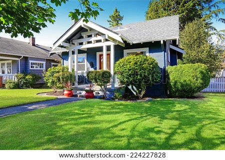 Simple house exterior with tile roof. Front porch with curb appeal