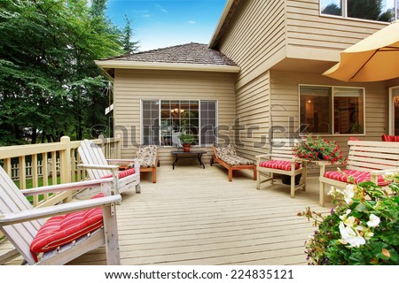 Wooden walkout deck with many deck chairs