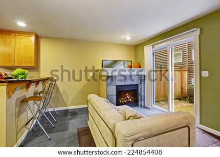 Cozy sitting area with fireplace and glass sliding doors to backyard area