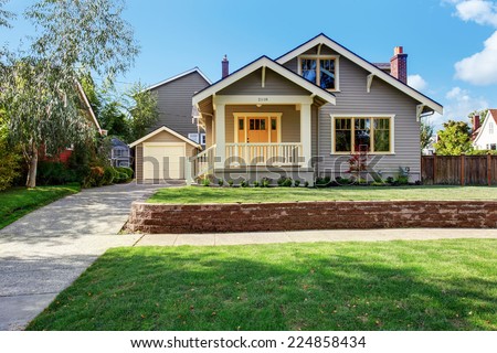 House exterior with front yard landscape. White entrance porch with railings and orange entrance door